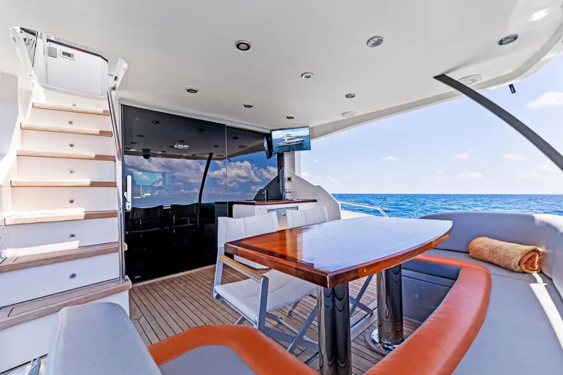 Slide: The Image of Luxurious 2014 Lazzara 64 yacht with outdoor seating, dining table, and ocean view. - 16