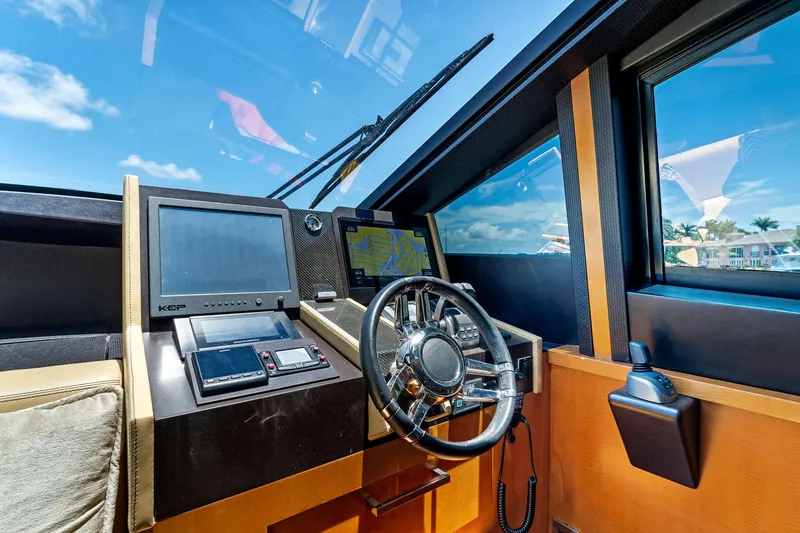 Slide: The Image of 2014 Lazzara 64 yacht helm station with navigation screens and steering wheel. - 30