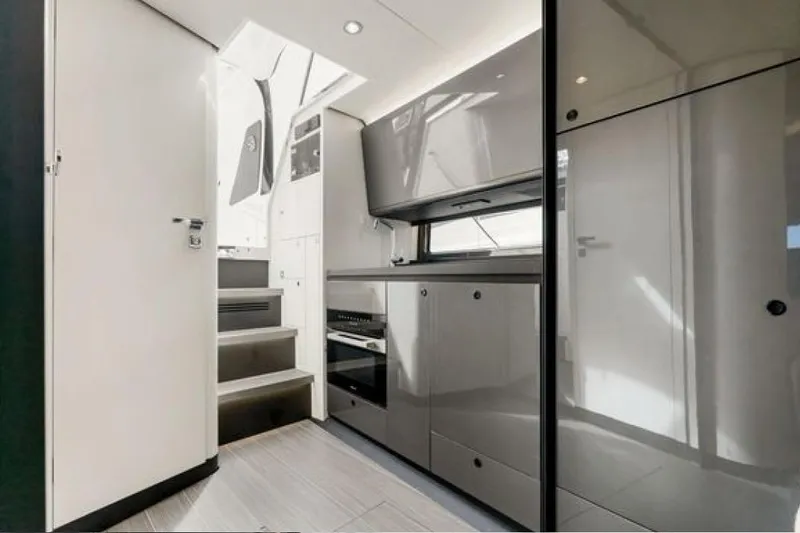 Slide: The Image of Modern interior of 2023 Azimut Verve 42 yacht, featuring sleek cabinetry and stairs. - 14