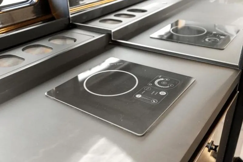 Slide: The Image of Modern kitchen cooktop on 2023 Azimut Verve 42 yacht, featuring sleek design and controls. - 16
