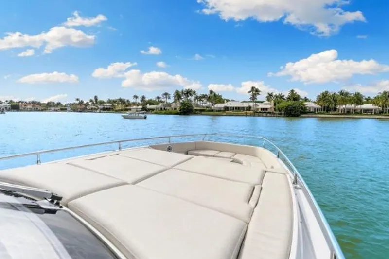 Slide: The Image of 2023 Azimut Verve 42 yacht cruising on a sunny day with scenic waterfront views. - 6