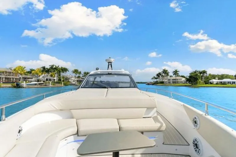 Slide: The Image of 2023 Azimut Verve 42 yacht cruising on a sunny day with palm trees in the background. - 8