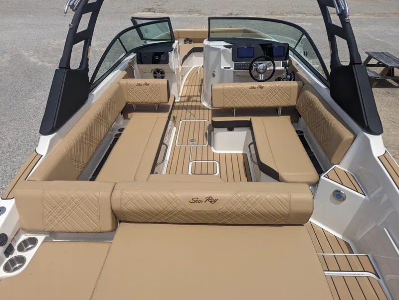 Slide: The Image of 2024 Sea Ray SDX 270 boat interior with tan seating and modern dashboard. - 10