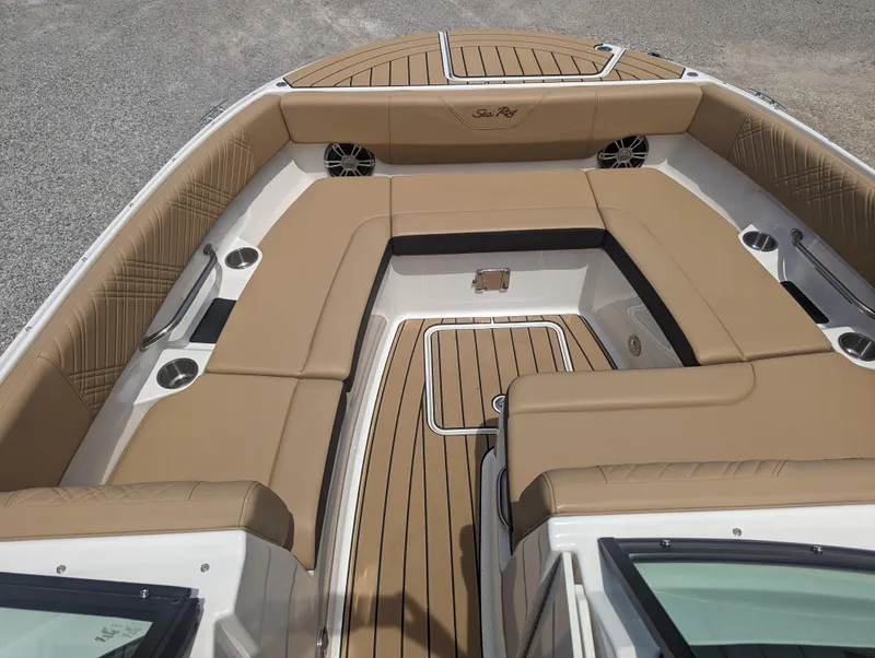 Slide: The Image of 2024 Sea Ray SDX 270 boat interior with tan seating and wood flooring. - 12