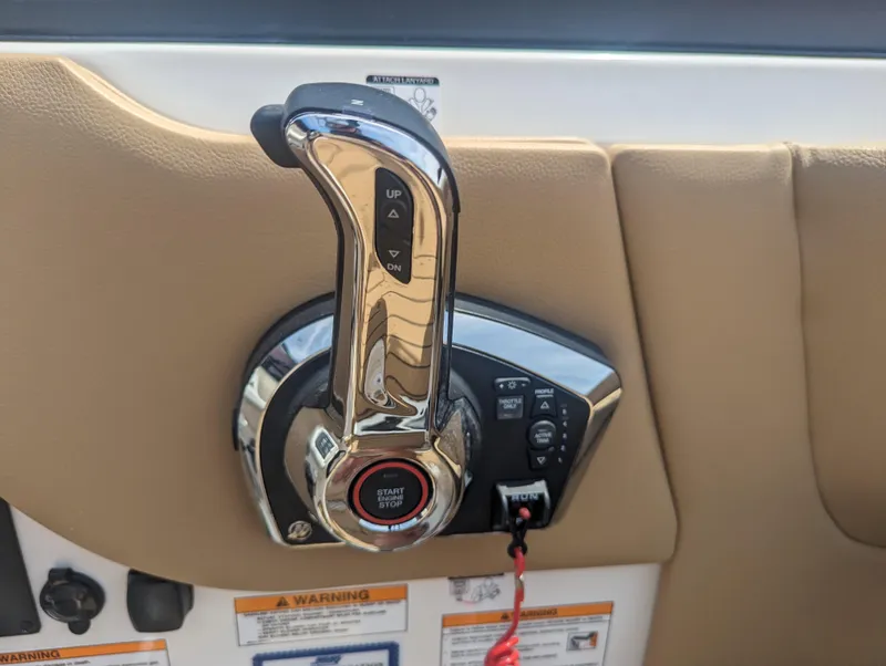 Slide: The Image of 2024 Sea Ray SDX 270 throttle control lever and ignition switch. - 15