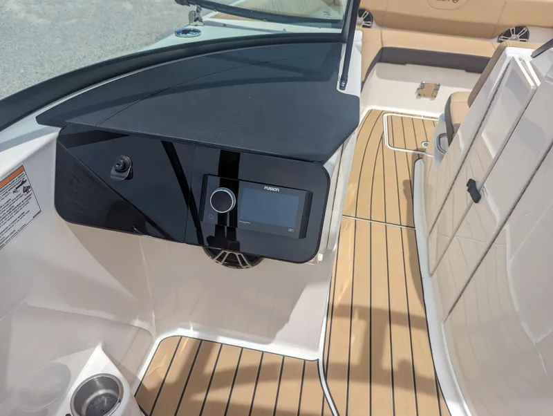 Slide: The Image of 2024 Sea Ray SDX 270 boat interior with modern dashboard and teak flooring. - 16