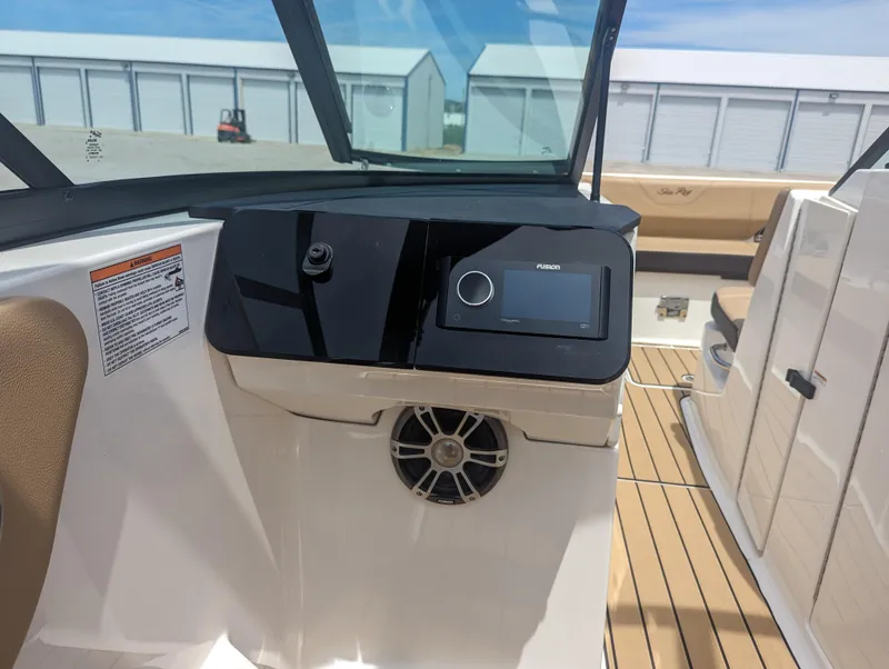 Slide: The Image of 2024 Sea Ray SDX 270 boat dashboard with modern controls and speaker. - 20