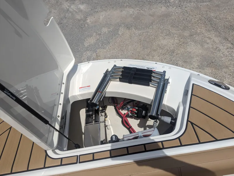 Slide: The Image of 2024 Sea Ray SDX 270 boat storage compartment with ladder and wiring. - 24