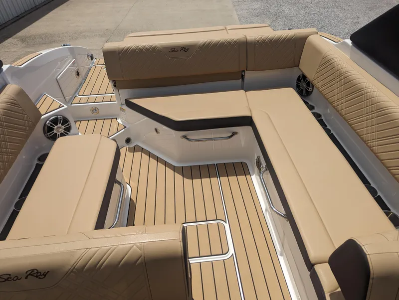 Slide: The Image of 2024 Sea Ray SDX 270 boat interior with tan seating and teak flooring. - 27