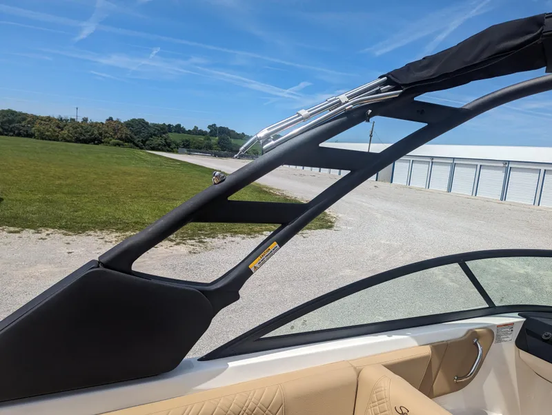 Slide: The Image of 2024 Sea Ray SDX 270 boat interior with black frame and beige seating. - 28