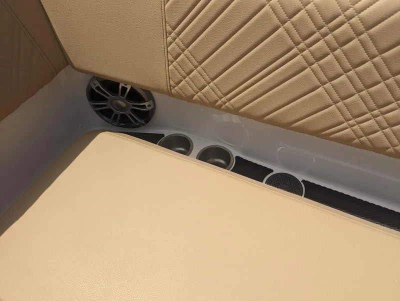 Slide: The Image of 2024 Sea Ray SDX 270 boat interior with beige upholstery and cup holders. - 31