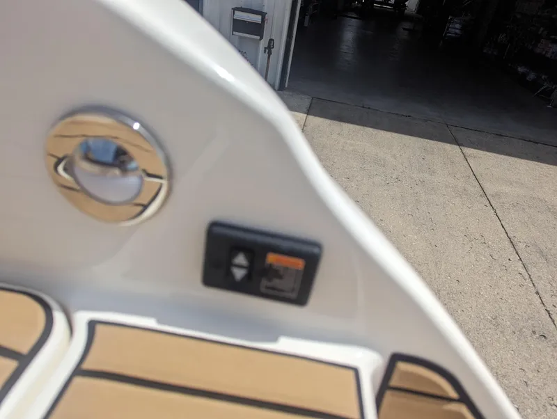 Slide: The Image of Close-up of 2024 Sea Ray SDX 270 boat interior with control panel and chrome fixture. - 36