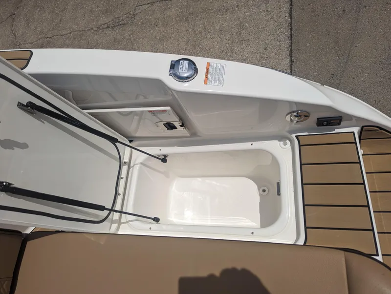 Slide: The Image of 2024 Sea Ray SDX 270 storage compartment with open lid. - 37