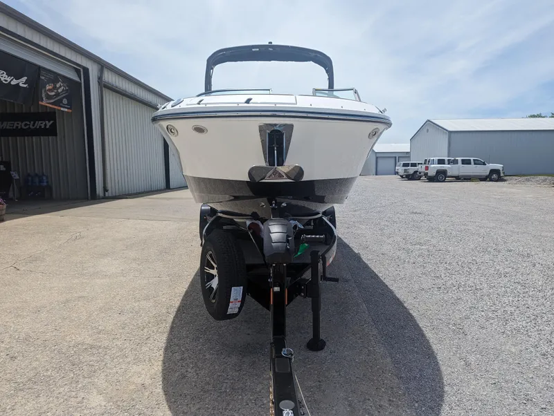 Slide: The Image of 2024 Sea Ray SDX 270 boat on a trailer in a marina parking lot. - 8
