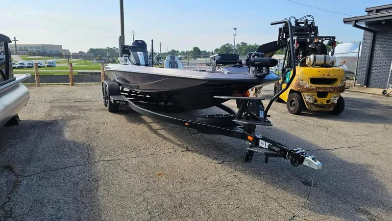 Slide: The Image of 2024 iKon LX21 boat on trailer in outdoor setting, with forklift nearby. - 6