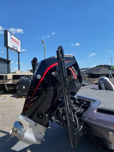 Slide: The Image of 2024 iKon LX20 boat with powerful outboard motor at a marine dealership. - 7