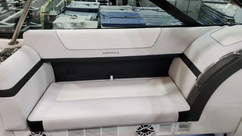 Slide: The Image of 2023 Formula 350 Crossover Bowrider I/O interior seating with white and black upholstery. - 13