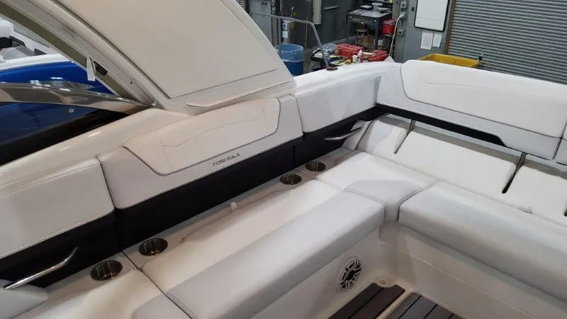 Slide: The Image of 2023 Formula 350 Crossover Bowrider I/O interior seating area with white upholstery. - 15