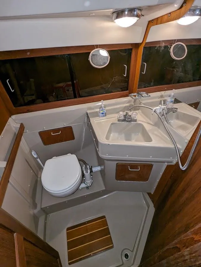 Slide: The Image of 1985 O'Day 35 sailboat bathroom with sink, toilet, and wood accents. - 12