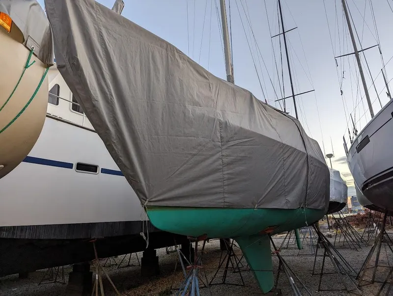 Slide: The Image of 1985 O'Day 35 sailboat covered and stored on land. - 18