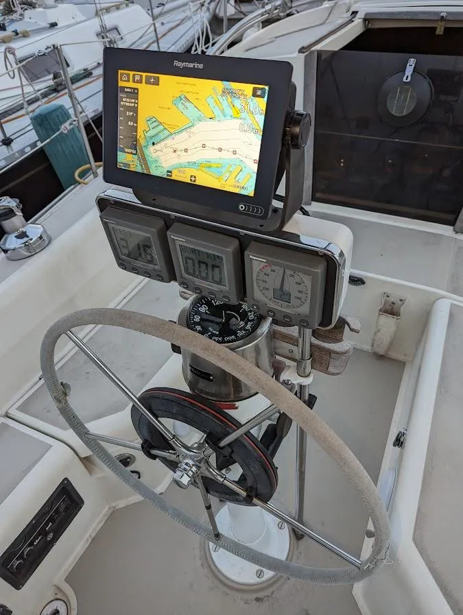 Slide: The Image of Cockpit of 1985 O'Day 35 sailboat with navigation equipment and steering wheel. - 2