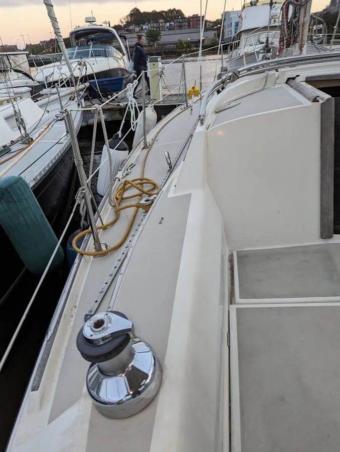 Slide: The Image of 1985 O'Day 35 sailboat deck with winch and ropes at marina. - 5