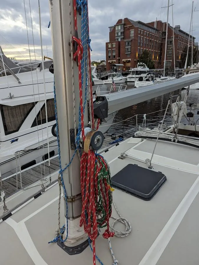 Slide: The Image of 1985 O'Day 35 sailboat deck with colorful ropes, docked in a marina. - 6