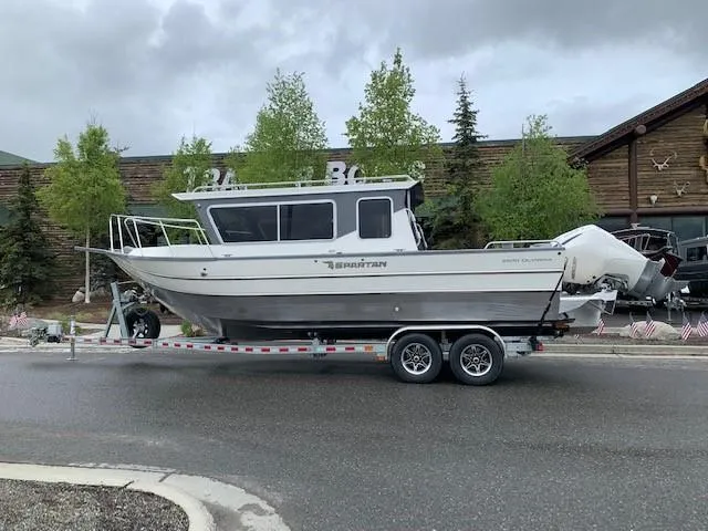 Slide: The Image of 2024 Spartan 2600 Olympia boat parked on trailer outdoors. - 1