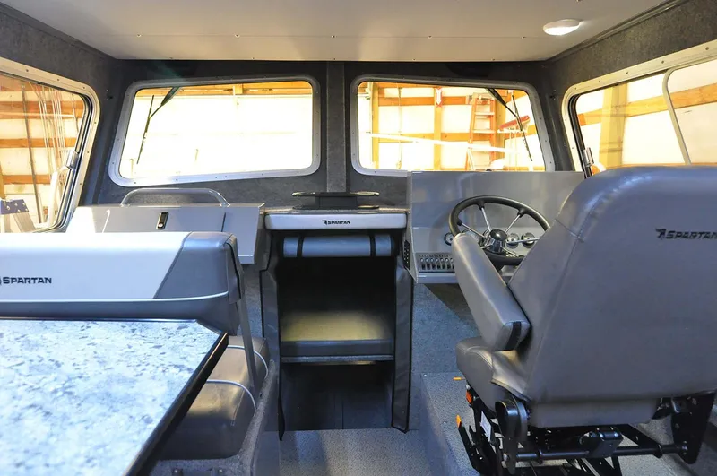 Slide: The Image of 2024 Spartan 2600 Olympia boat deck with storage compartments and twin outboard motors. - 11