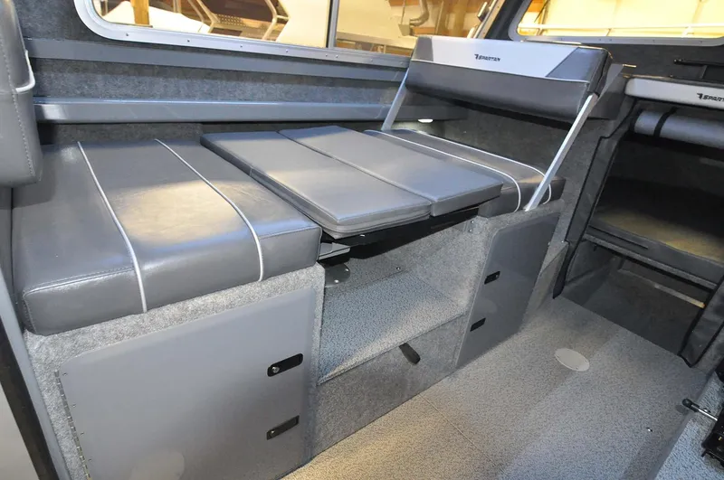 Slide: The Image of 2024 Spartan 2600 Olympia boat interior with steering wheel and control panel. - 14