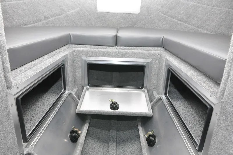 Slide: The Image of 2024 Spartan 2600 Olympia interior with compact seating and storage area. - 18