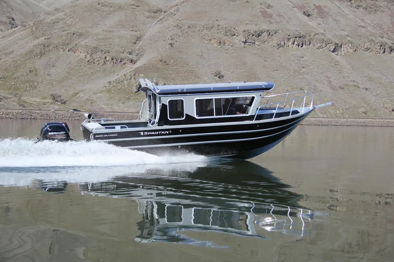 Slide: The Image of 2024 Spartan 2600 Olympia boat with dual Mercury 200 V6 engines, parked outdoors. - 5