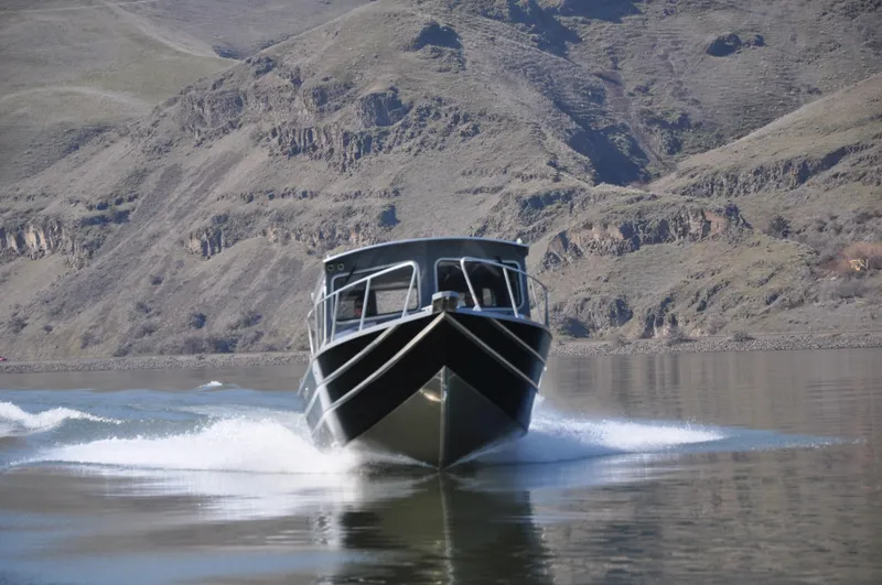 Slide: The Image of 2024 Spartan 2600 Olympia boat on trailer with dual outboard motors. - 6