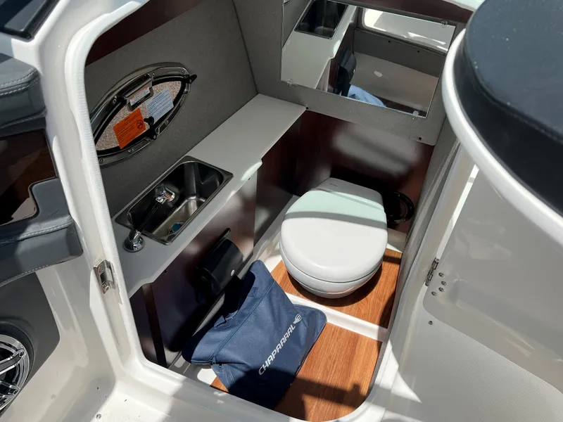 Slide: The Image of 2024 Chaparral 287 SSX boat interior with sink, toilet, and mirror. - 3