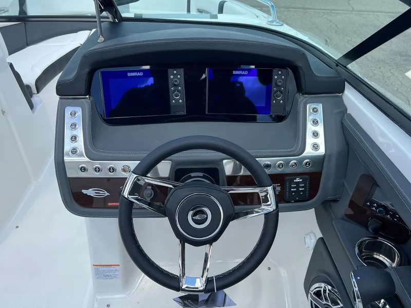 Slide: The Image of 2024 Chaparral 287 SSX boat dashboard with dual Simrad displays and modern controls. - 5