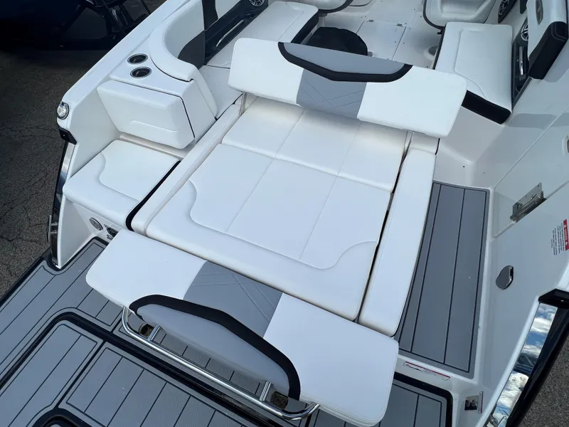 Slide: The Image of 2024 Chaparral 287 SSX boat interior with white and gray seating. - 7
