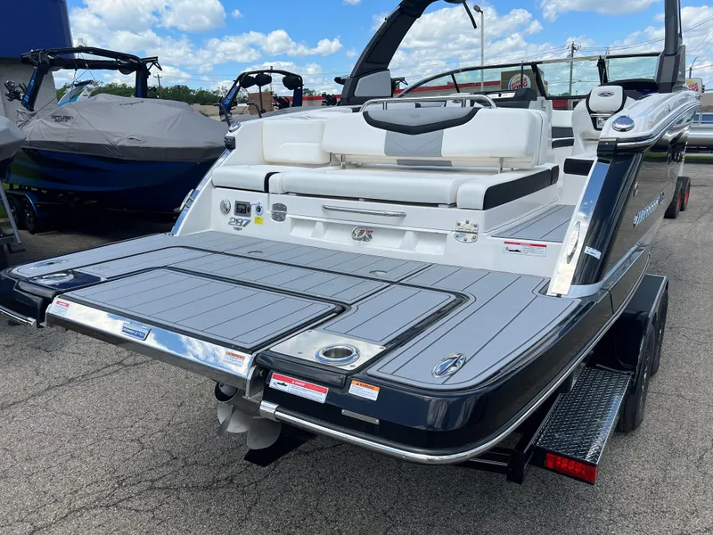 Slide: The Image of 2024 Chaparral 287 SSX boat rear view with swim platform and seating. - 8