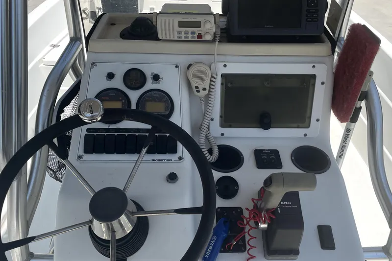 Slide: The Image of 2004 Skeeter ZX 2400 boat console with steering wheel, gauges, and navigation equipment. - 10