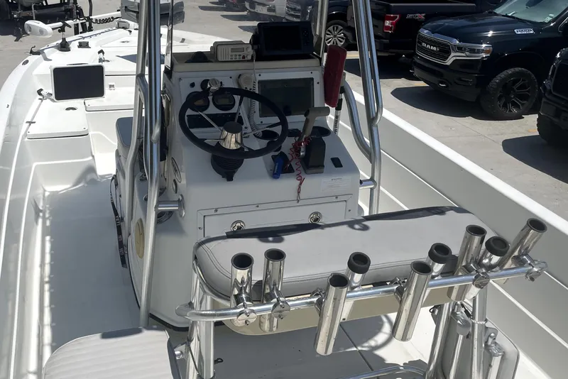 Slide: The Image of 2004 Skeeter ZX 2400 boat interior with steering console and rod holders. - 11