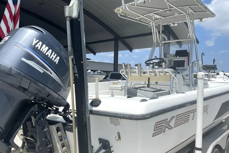 Slide: The Image of 2004 Skeeter ZX 2400 boat with Yamaha outboard motor in a marina. - 4