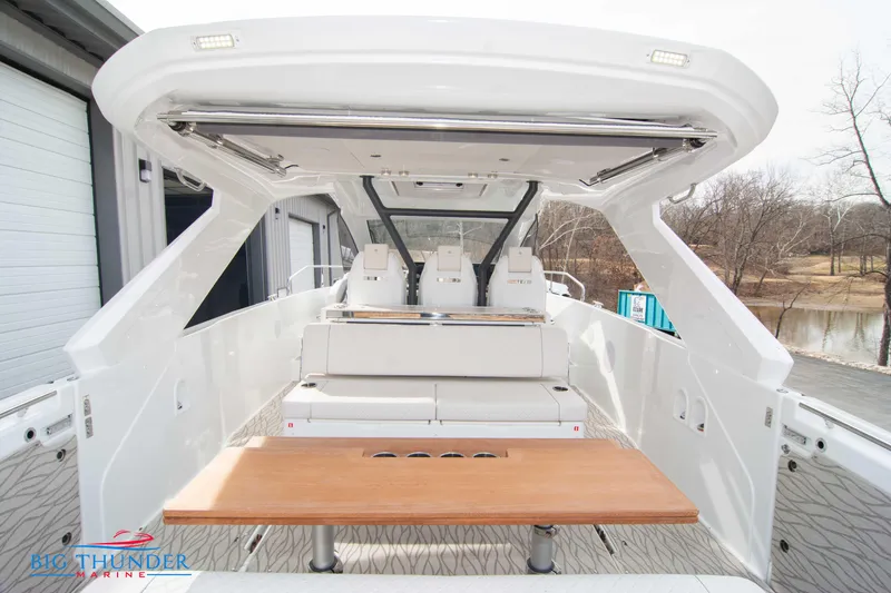 Slide: The Image of 2024 Jeanneau DB/37 OB boat interior with seating and table. - 13
