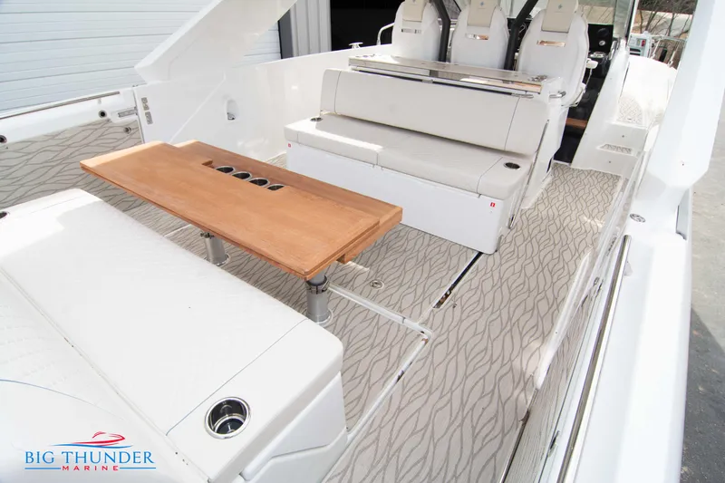 Slide: The Image of 2024 Jeanneau DB/37 OB boat interior with seating and wooden table. - 15