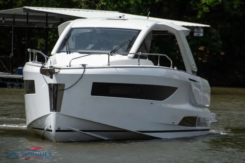 Slide: The Image of 2024 Jeanneau DB/37 OB luxury motorboat cruising on a river. - 2