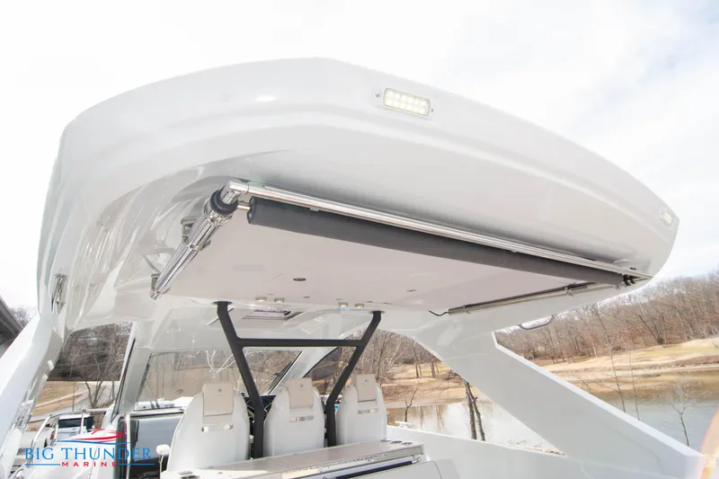 Slide: The Image of 2024 Jeanneau DB/37 OB boat with retractable sunshade and seating area. - 23