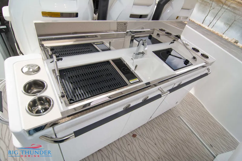 Slide: The Image of 2024 Jeanneau DB/37 OB boat kitchen with grill, sink, and storage. - 28