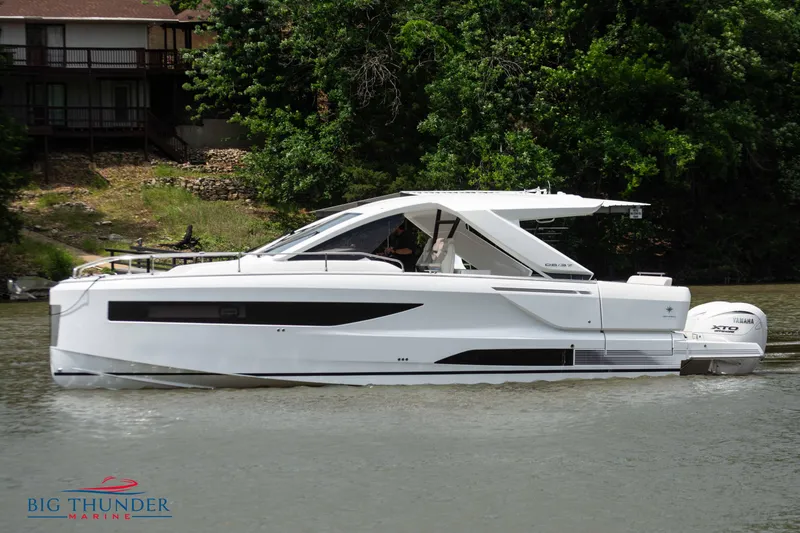 Slide: The Image of 2024 Jeanneau DB/37 OB luxury motorboat on a calm river. - 3