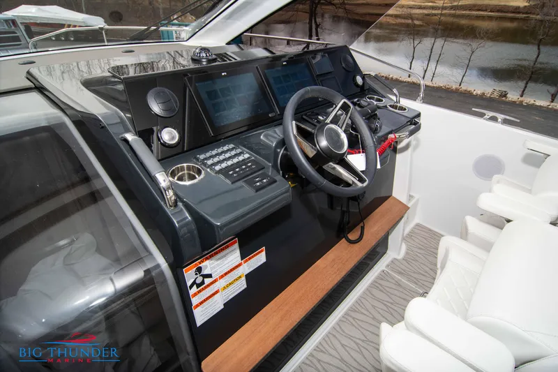 Slide: The Image of 2024 Jeanneau DB/37 OB boat helm with modern controls and dual seats. - 38