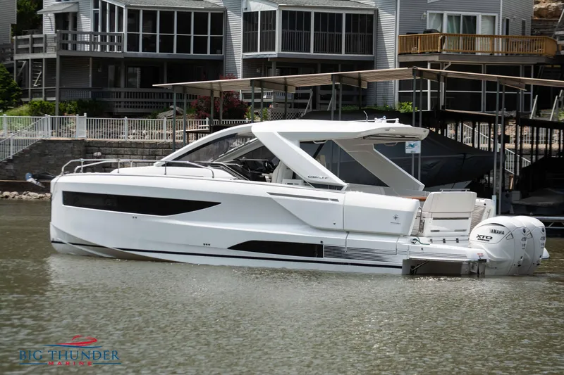 Slide: The Image of 2024 Jeanneau DB/37 OB boat docked near waterfront homes. - 4