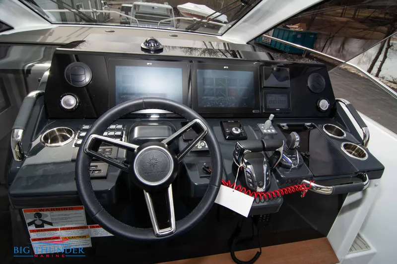 Slide: The Image of 2024 Jeanneau DB/37 OB helm with modern controls and touchscreen displays. - 40