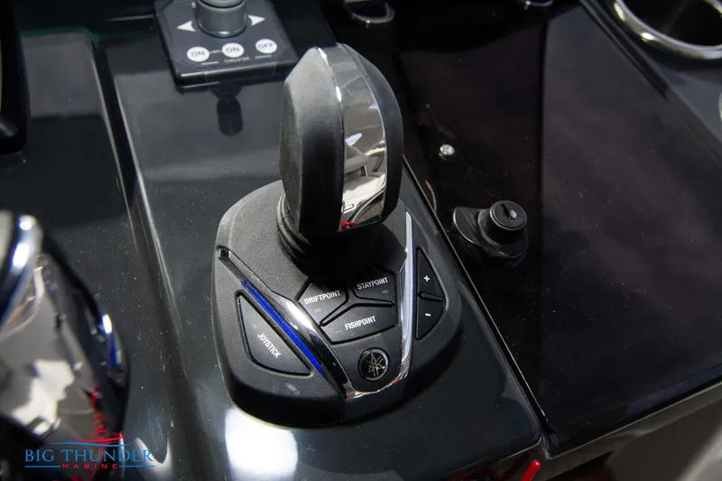 Slide: The Image of 2024 Jeanneau DB/37 OB boat control panel with joystick and buttons. - 49